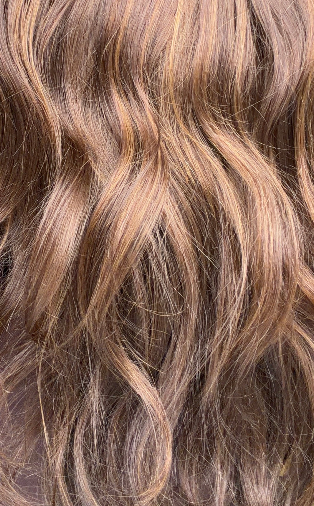 Close up image of wavy brown hair.